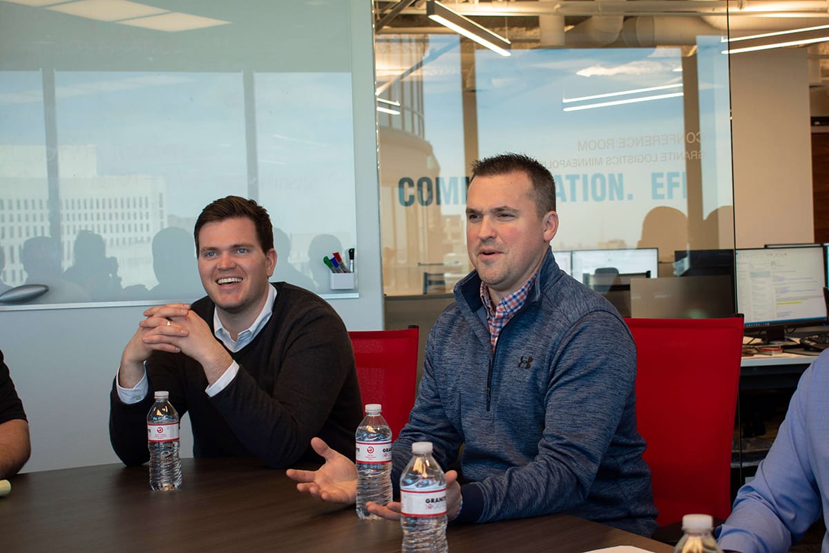 Granite Logistics employees joking around conference room table